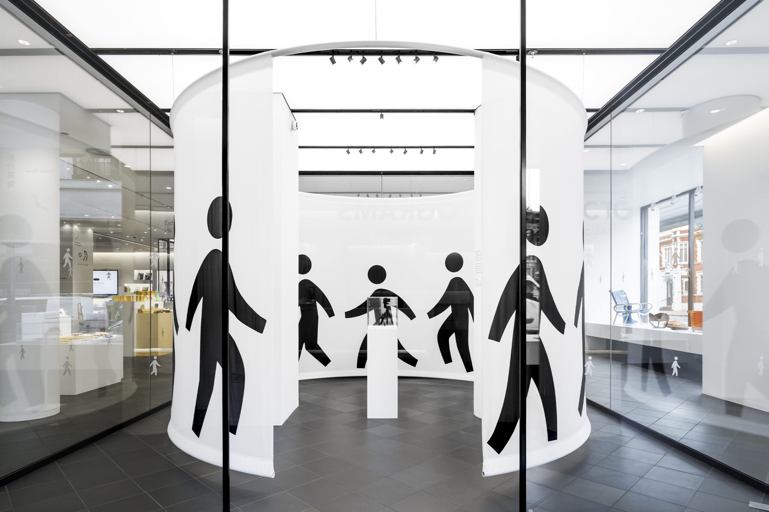 Exterior shot showing visitors and interior highlights of the Pictograms exhibition.