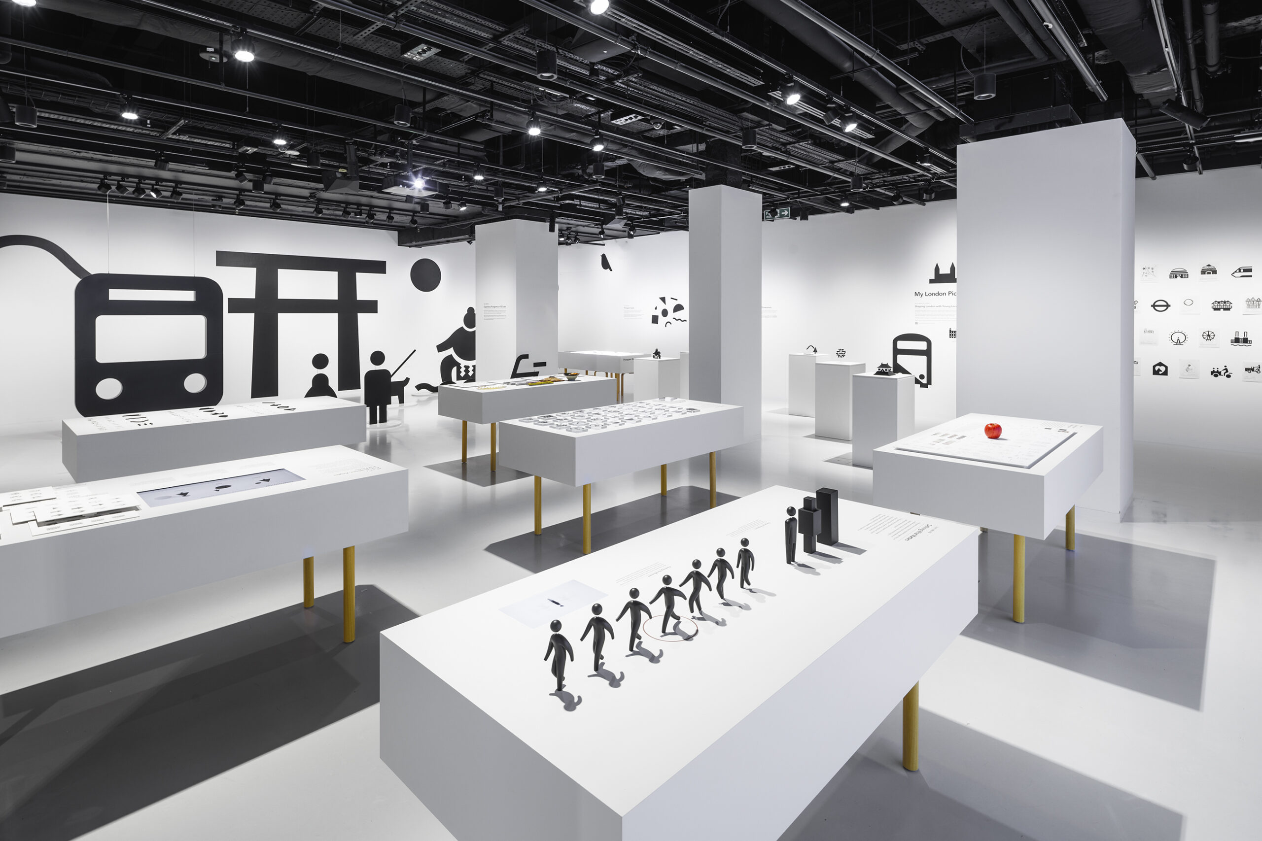 Wide interior view of the Pictograms exhibition showcasing spatial design and visual storytelling.