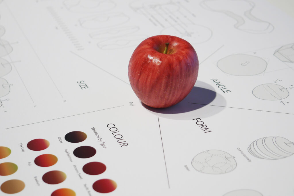 Panel showing the design process of a pictogram derived from the shape of an apple.
